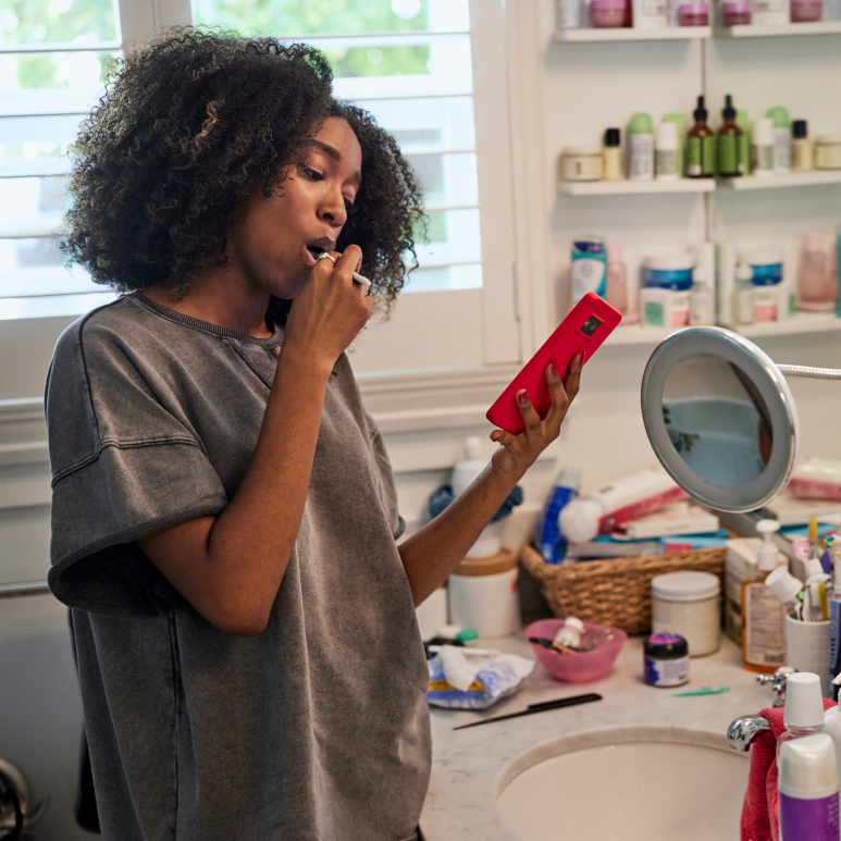 Woman brushing teeth in bathroom