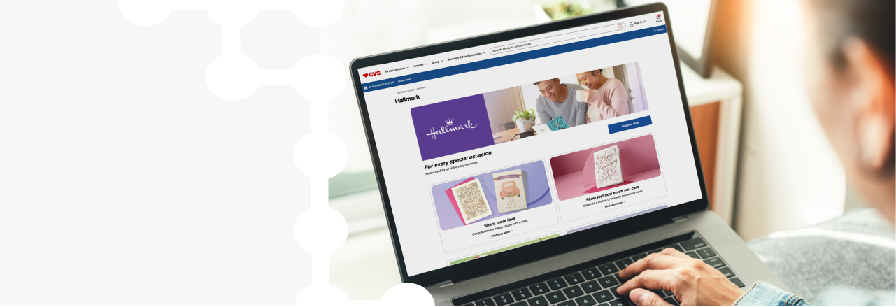 A person on a laptop browsing a Hallmark campaign on CVS.com