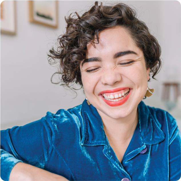 Woman wearing lipstick, smiling.
