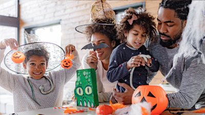 A family happily prepares Halloween decorations