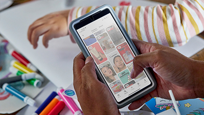 a person holding a phone scrolling through the cvs health app
