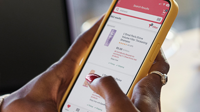 a person holding a phone scrolling through the cvs health app