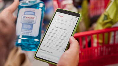 Laptop displays a sponsored brand page for Well Market products